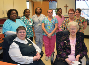 Sister Lenore and Sister Patricia with staff at St. Joseph’s Home.